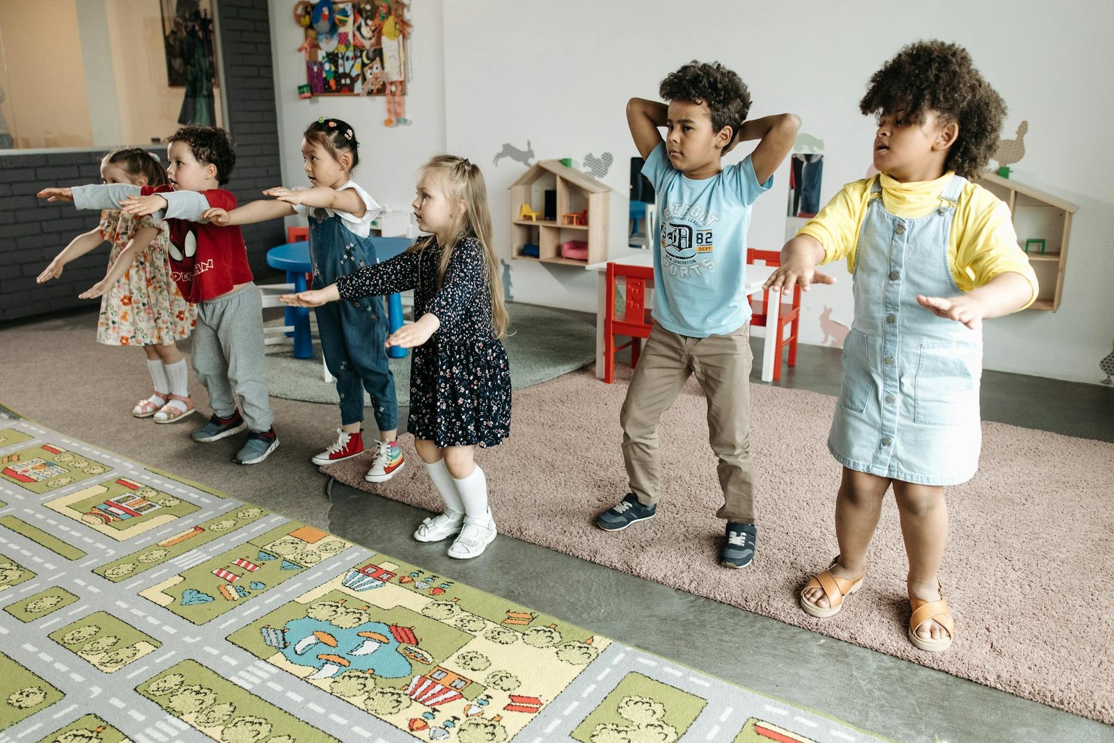 A diverse group of children participating in a fun educational activity indoors.